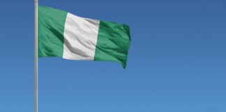 Flag of Nigeria in front of a clear blue sky